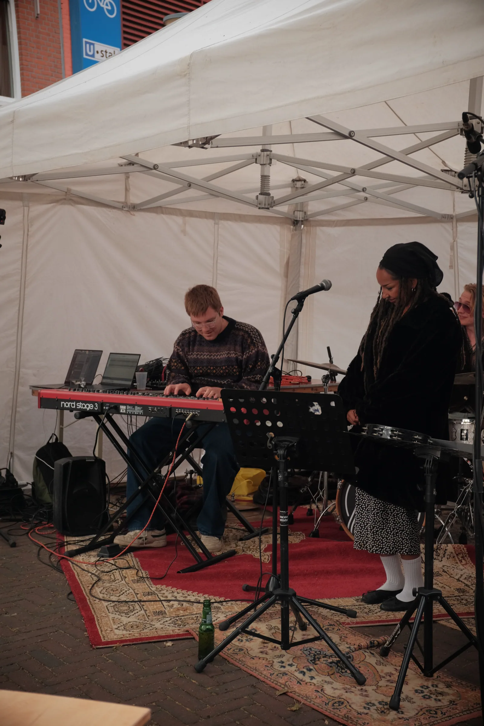 Jack Hansen playing keyboard with a singer at an outdoor show