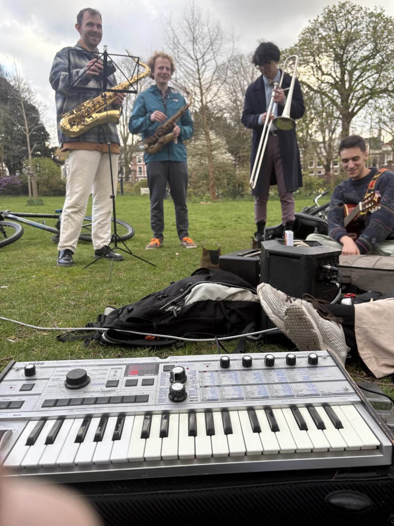 A keyboard and band setting up for an outdoor performance
